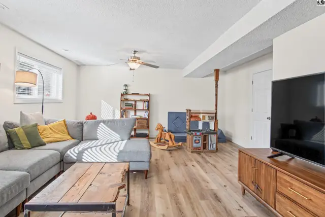 Spacious living area with a sectional sofa, coffee table, and entertainment console.